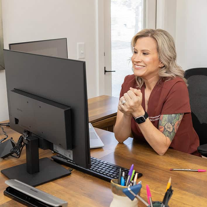 Root-Cause Healthcare provider reviewing patient information and planning care at a professional office desk