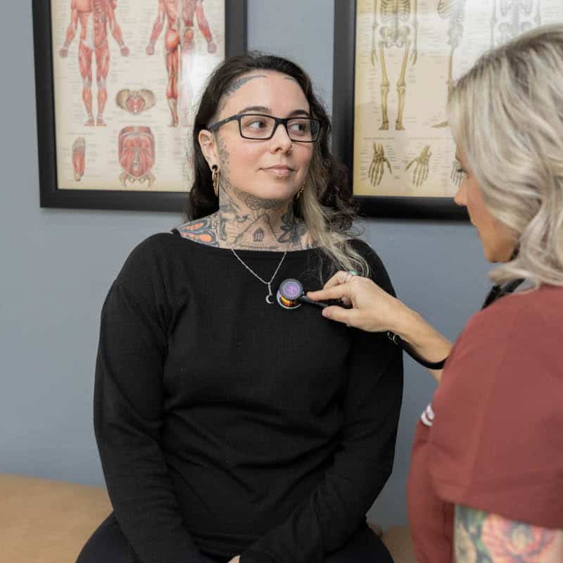 Holistic Healthcare provider performing a gentle assessment during a personalized wellness visit